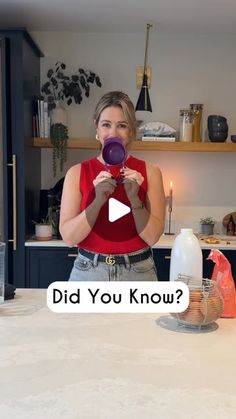 a woman standing in front of a kitchen counter holding a purple object with the words did you know?