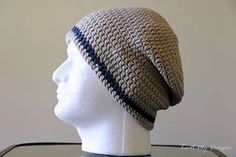 a white mannequin head wearing a gray and blue crochet beanie