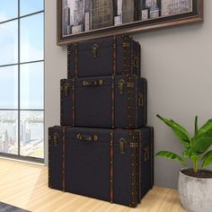 three suitcases stacked on top of each other in front of a window with cityscape