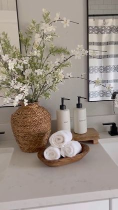 a bathroom with white flowers and towels on the counter