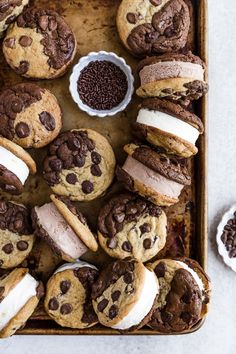 chocolate chip cookies and marshmallows are arranged on a baking sheet