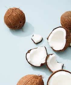 coconuts cut in half on a blue surface