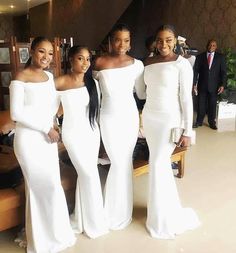 three women in white dresses standing next to each other