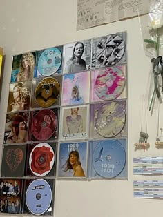 there are many cd's hanging on the wall