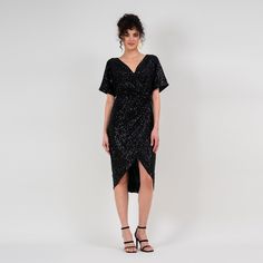 Midi length dress made in sequin black fabric, with V neckline and flowy sleeves. Dry clean only. Black V-neck Sequin Dress For Cocktail, Glamorous Sequined V-neck Evening Dress, Short Sleeve Sequin Dress For Gala, V-neck Contrast Sequin Dress For Date Night, Contrast Sequin V-neck Dress For Date Night, Black V-neck Sequin Dress With Contrast Sequins, V-neck Sequin Evening Dress For Date Night, Black Evening Dress With Draped Sleeves, Black V-neck Sequin Evening Dress