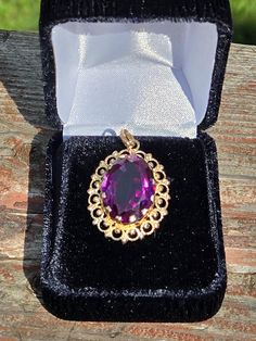 Fresh from estate is this rare opportunity to aquire this spectacular estate 1970-80s vintage 14k yellow gold pendant with a striking large deep purple synthetic color change sapphire. In all my years searching estates I have never come across a unique piece like this! Pendant is solid 14k yellow gold with a large synthetic dark purple color change sapphire measuring 20 mm X 15 mm in size. Pendant measues about 30 mm tall by 23 mm wide. Pendant is stamped and tested with professional gold testin Color Change Sapphire, American Dollar, Sapphire Pendant, Yellow Gold Pendants, 80s Vintage, Vintage Jewellery, Watch Video, Vintage 1970s, Dark Purple