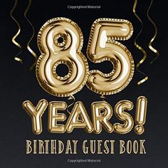 the 85th birthday guest book with gold foil balloons and streamers in the shape of numbers