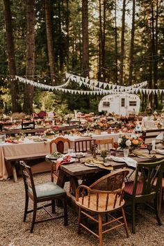 an outdoor table set up for a party with bunting and flags in the background