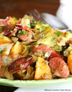 a close up of a plate of food with meat and vegetables on it next to a fork