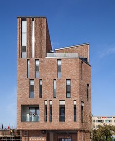 a tall brick building with lots of windows