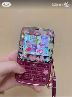 a person holding up a cell phone with many stickers all over it's screen