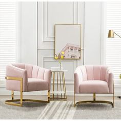 two pink chairs in front of a white wall