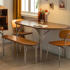 a dining room table with four chairs around it