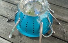 a blue colander sitting on top of a wooden table