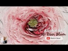 a close up of a pink flower on a white plate with the words alcohol ink