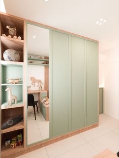 an open closet with shelves and toys in the corner, along with a mirror on the wall