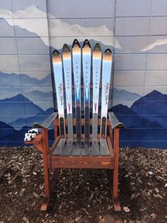 a chair made out of skis sitting in front of a wall