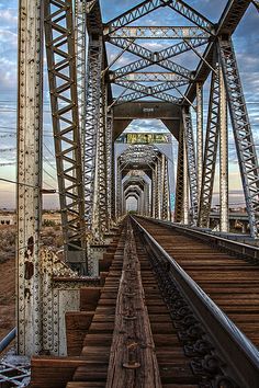 an old train track going across a bridge