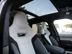 the interior of a car with black and white seats