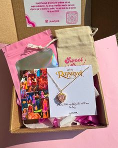 an open box containing a necklace and some other items, including a note card with the words sweet as can be written on it