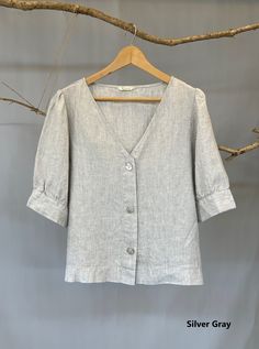 "Classic white and black women V-neck button down blouse, easy to be layered with camisole as a shirt or by itself as a blouse. The puffy sleeves are very flattering; pair it with pants, jeans or skirts for a chic and young look. - Prewashed medium weight linen (180g) - Relaxed fit - Button down opening - Elbow-length puffed sleeves with cuff and button - Can be tucked or untucked Please provide your shoulder width, full bust measurement ( measured around the fullest part) and your height in the Casual Linen Puff Sleeve Tops, Casual Linen Puff Sleeve Top For Spring, Spring Linen Puff Sleeve Top, Relaxed Fit Short Sleeve V-neck Top For Work, Relaxed Fit V-neck Top For Work With Short Sleeves, Spring V-neck Tops With Cuffed Sleeves, Casual Linen Puff Sleeve Top For Summer, V-neck Linen Blouse For Work, Summer Linen Blouse With Puff Sleeves