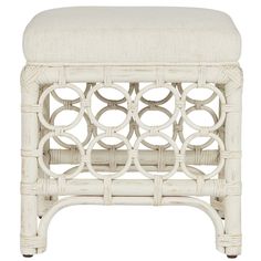 an upholstered white bench with circles on the back and seat cushion, made from wicker