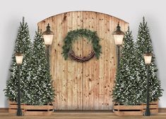 a wooden wall with christmas wreaths and lights on it next to two benches in front of trees