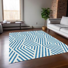 a blue and white area rug in a living room