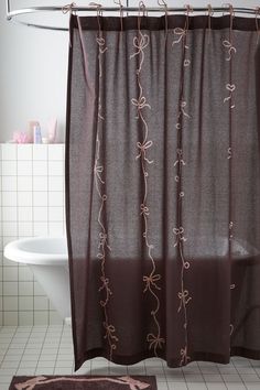 a bathroom with a bathtub, sink and shower curtain