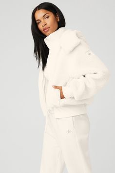 Easy come, easy go. Cut from cozy sherpa and equipped with a removable hood and zip pockets, our ultra-comfy Foxy Sherpa Jacket will get you to the studio every time. Features a front-zip closure, oversized silhouette and ribbed cuffs and hem. On-trend oversized fit Removable hood & zippered pockets Designed to work from studio to street Wear-tested by our in-house team for the perfect fit Snow Angel, Sherpa Jacket, Back Women, Oversized Silhouette, Cute Skirts, Alo Yoga, Light Jacket, Bra Tops, The Studio