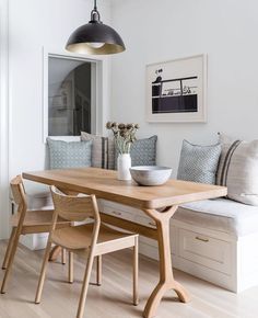 a dining room table with two chairs and a bench