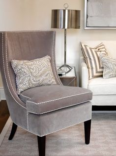 a living room filled with furniture and pillows