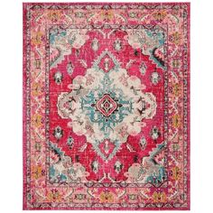 a pink and blue area rug with an ornate design on the center, surrounded by multicolored flowers