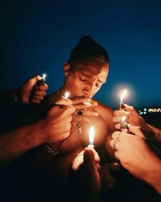 three men holding lighters in their hands and looking at them with the lights on