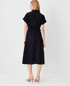 Elevate your wardrobe with the Ann Taylor Crossover Collared Midi Shirtdress, a versatile piece that promises effortless style and comfort. Perfect for a variety of occasions, this dress features a flattering crossover front and a chic point collar.

- **Size:** Regular 00
- **Color:** Black
- **Gender:** Female
- **Material:** Shell: 67% Lyocell, 18% Linen, 15% Viscose; Lining: 100% Polyester
- **Sleeve Length:** Short
- **Length:** 28 inches from natural waist
- **Fit:** Hits below the knee
- Black Belted Dress With Tie Waist For Work, Chic Black Belted Dress With Short Sleeves, Black Belted Dress For Spring Workwear, Spring Workwear Black Belted Dress, Black Belted Collared Dress, Black Shirt Dress With Tie Waist For Summer, Short Sleeve Tie Waist Shirt Dress For Fall, Short Sleeve Shirt Dress With Tie Waist For Fall, Belted Short Sleeve Shirt Dress For Fall