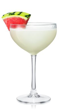 a white wine glass with a watermelon slice on the rim next to it