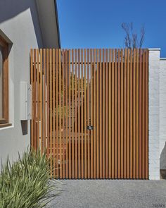 a wooden fence is in front of a house