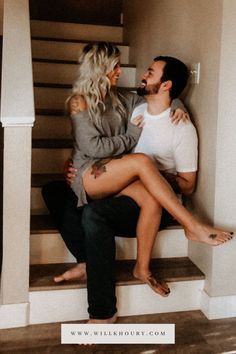 a man and woman sitting on some stairs