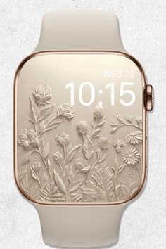 an apple watch with flowers and leaves on the face, which reads wed 23 10 15