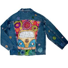 a denim jacket with an image of a bus painted on the back and colorful swirls