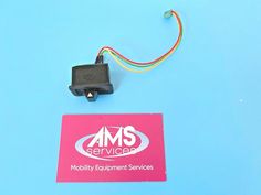 an ams service logo is attached to a piece of electronic equipment on a blue background