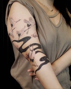 a woman with a bird tattoo on her arm