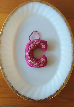 a small pink object sitting on top of a white plate