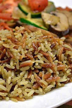 a white plate topped with rice and veggies