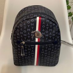 Brand New Tommy Hilfiger Women’s Tommy Logo Faux Leather Black Backpack. Brand New With Original Tags Adjustable Backpack Straps Backpack For Women Featuring The Tommy Hilfiger Signature Flag Stripe And Metal Th Hardware Exterior Front Pocket Lined Nylon Interior With Wall Zip Pocket And Slip Pocket Backpack Size: Height: 11" Width: 9" Depth: 5.5" No Return Tommy Hilfiger Backpack Black, Tommy Hilfiger Travel Bags With Zipper Closure, Trendy Tommy Hilfiger Bags With Zipper Closure, Tommy Hilfiger Travel Backpack, Tommy Hilfiger Bags, Backpack For Women, Black Leather Backpack, Backpack Straps, Tommy Hilfiger Women