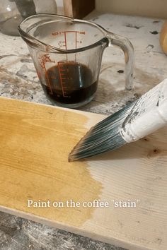 paint on the coffee stain is being poured into a measuring cup