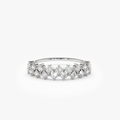 a white gold ring with five diamonds on the side, set in 18k white gold