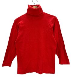 "Vintage sizes are different from modern sizes, often run much smaller, and differ from brand to brand. Please purchase based on measurements below and not based on tag size  DESCRIPTION This is a Vintage 90's Calvin Klein Red Turtleneck Long Sleeve T-Shirt. Fits like a Women's Small (please see measurements below to ensure a proper fit). Great design! CONDITION Vintage Preowned Condition - show signs of wear and fading due to age and normal use. There is a hole at the shoulder. Please see reference photos. MEASUREMENTS Underarm to Underarm: 16.5\" Top of Shoulder to Bottom Hem: 23.5\"  SHIPPING Item will be tightly folded. Please message us for International Shipping. International buyers are responsible for any import/duty fees their countries impose." Stretch 90s Style Tops For Fall, Stretch 90s Tops For Fall, Stretch Tops For Fall In 90s Style, Classic Stretch Red Tops, Classic Red Stretch Tops, 90s Style Red Tops For Winter, Red 90s Style Winter Tops, Red 90s Style Tops For Fall, Cotton Turtleneck T-shirt For Fall