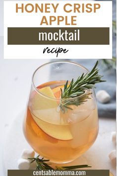 honey crisp apple mulled in a glass with rosemary garnish on the rim