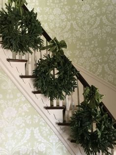 the stairs are decorated with green plants and candles on them for decorating this room